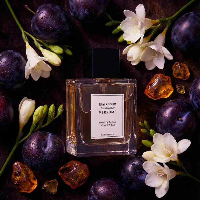 Black Plum Freesia Amber perfume oil bottle with dark plums, freesia flowers and glowing amber crystals under night lighting.