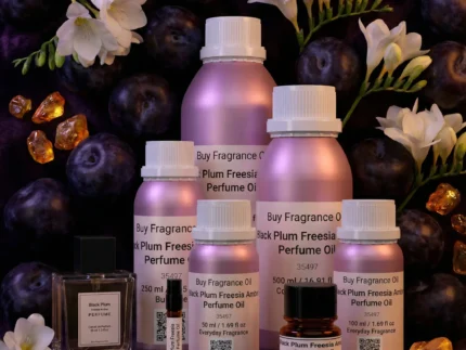 Black Plum Freesia Amber perfume oil bottle with dark plums, freesia flowers and glowing amber crystals under night lighting.