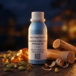Cardamom Cedar Amber perfume oil bottle with dark amber tones, spicy cardamom warmth and elegant woody night atmosphere.