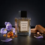 Iris Amber Cedar perfume oil bottle with iris flowers, amber tones and cedarwood elements in a dark elegant setting.
