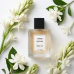Tuberose Gardenia Musk perfume oil bottle surrounded by white tuberose and gardenia flowers in soft daylight elegance.