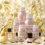 jasmine ylang pear perfume oil background with fresh pear, soft white flowers and golden sunlight glow in a clean elegant atmosphere