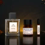 Oud amber spice perfume oil background with dark smoky oud wood, glowing amber resin and warm oriental spice atmosphere.